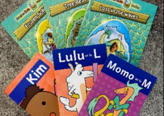 Thin colourful books displayed on a table.